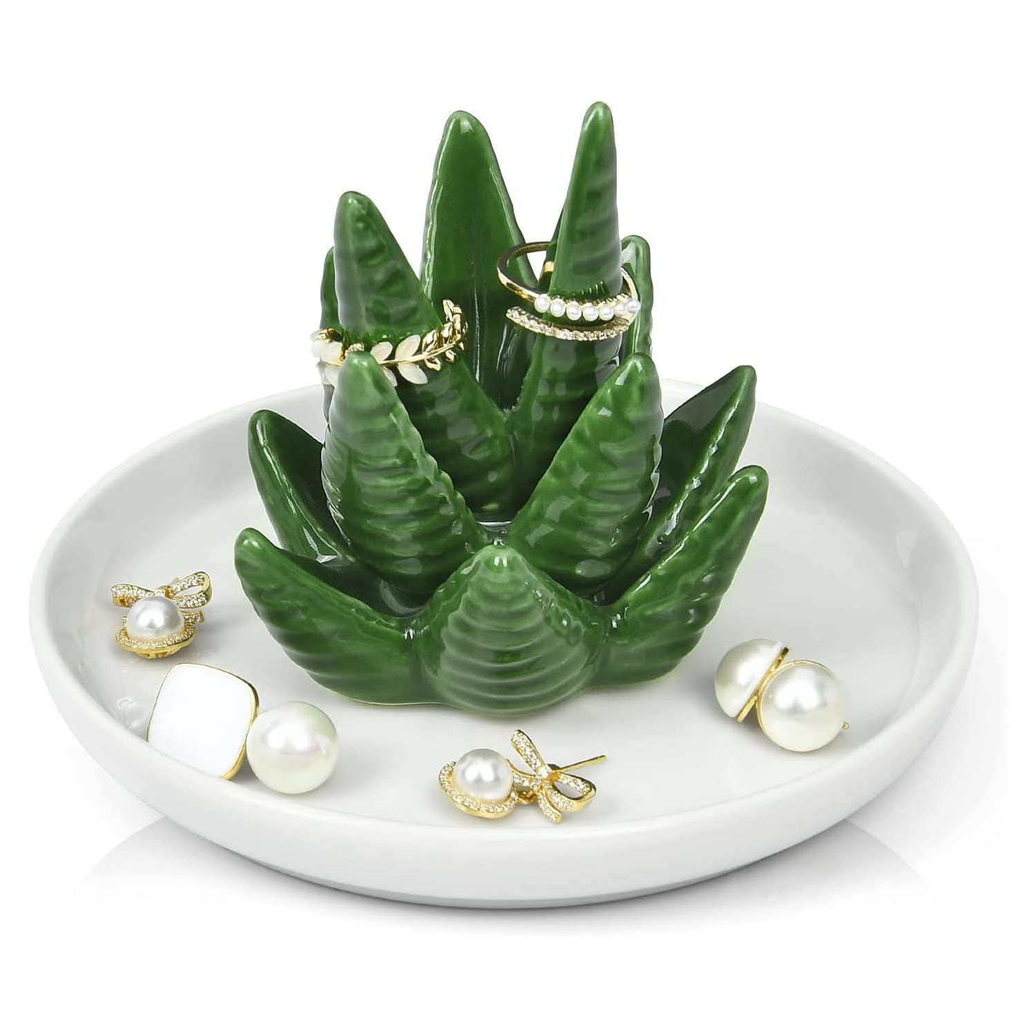 Green ceramic succulent ring holder with jewelry on a white plate