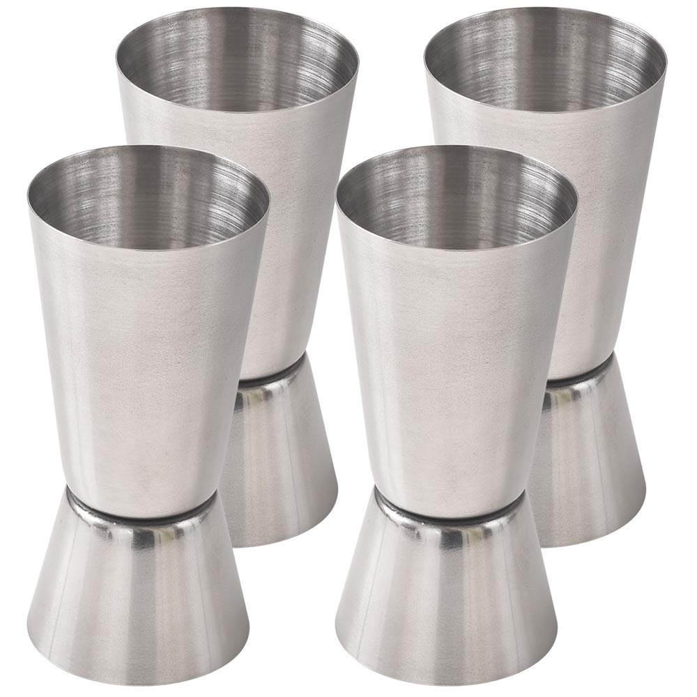 Four stainless steel jigger measuring cups, angled and stacked