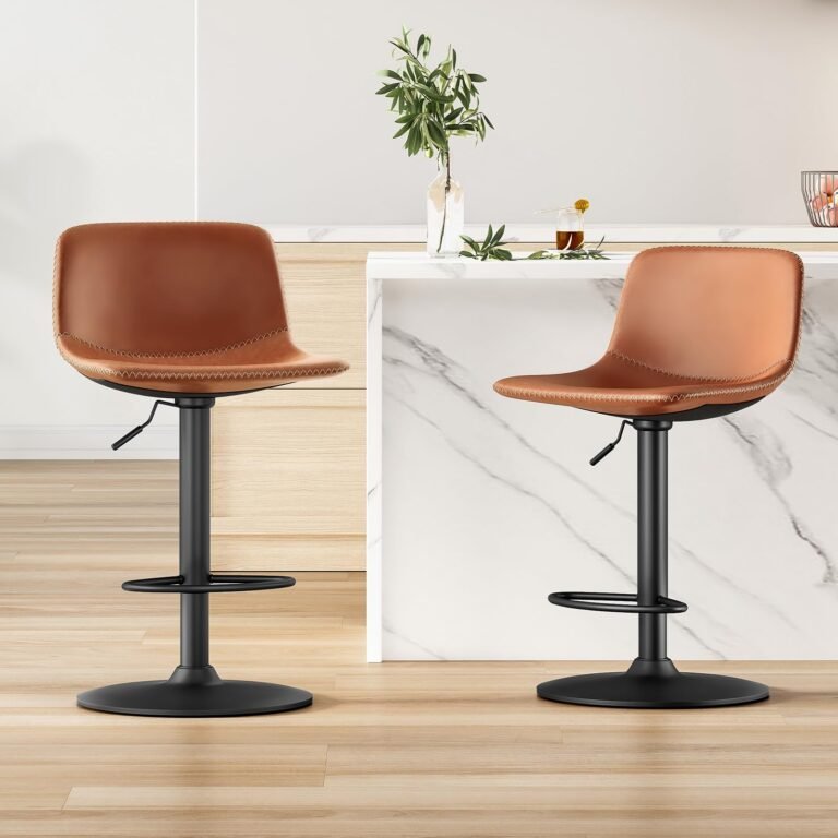 Two brown leather bar stools with black bases in a kitchen