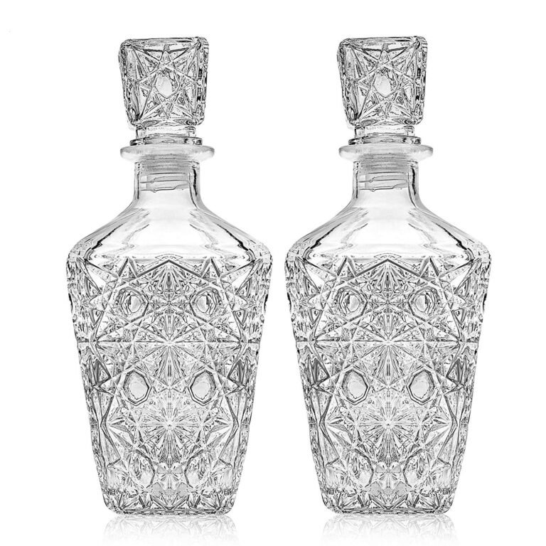 Two ornate crystal decanters with geometric patterns and stoppers