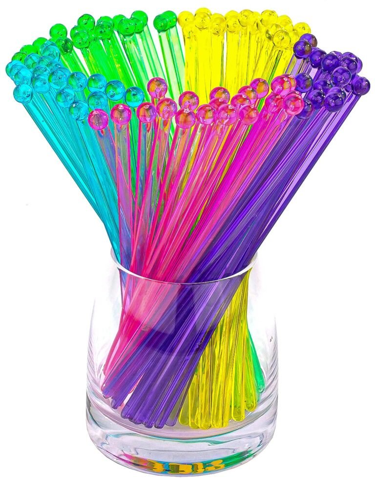 Colorful plastic drink stirrers with ball tops in a clear glass