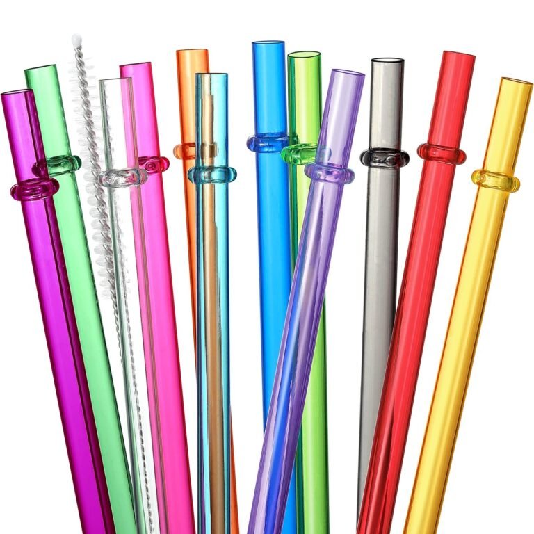Colorful reusable glass straws with a cleaning brush, arranged on white background