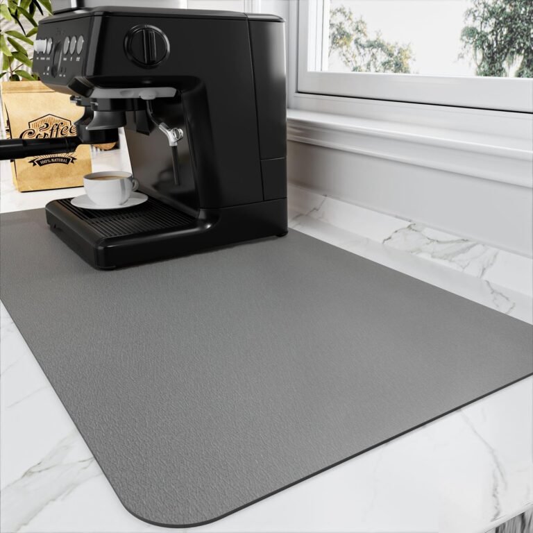 Black espresso machine with coffee cup on a gray countertop mat