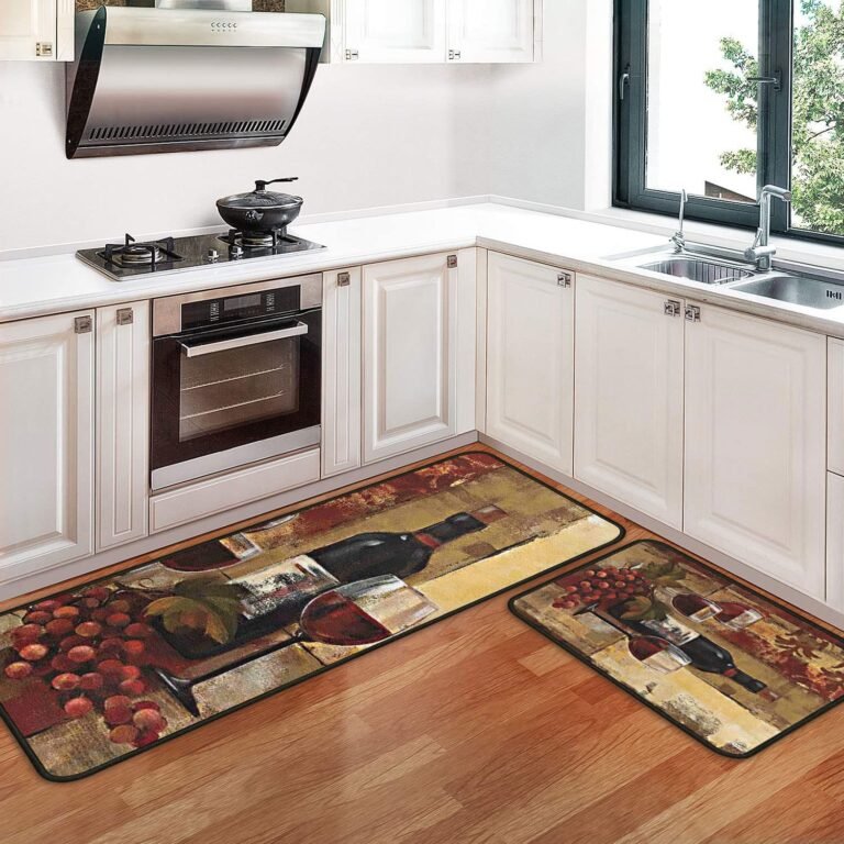 Kitchen with wine-themed rugs, stove, oven, and sink
